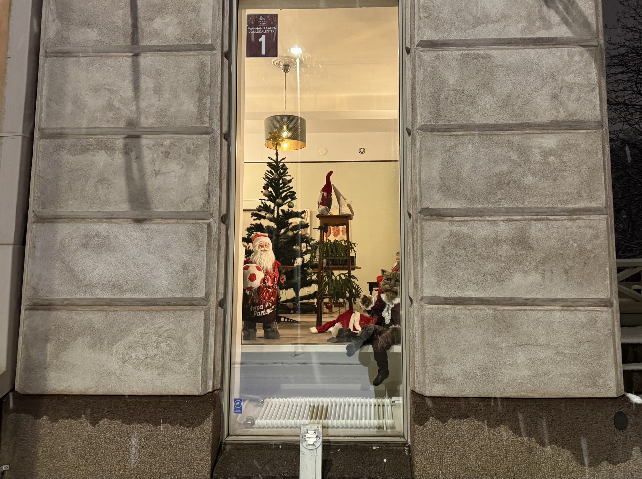 A santa, elfs and a Christmas cat peeking through the window.