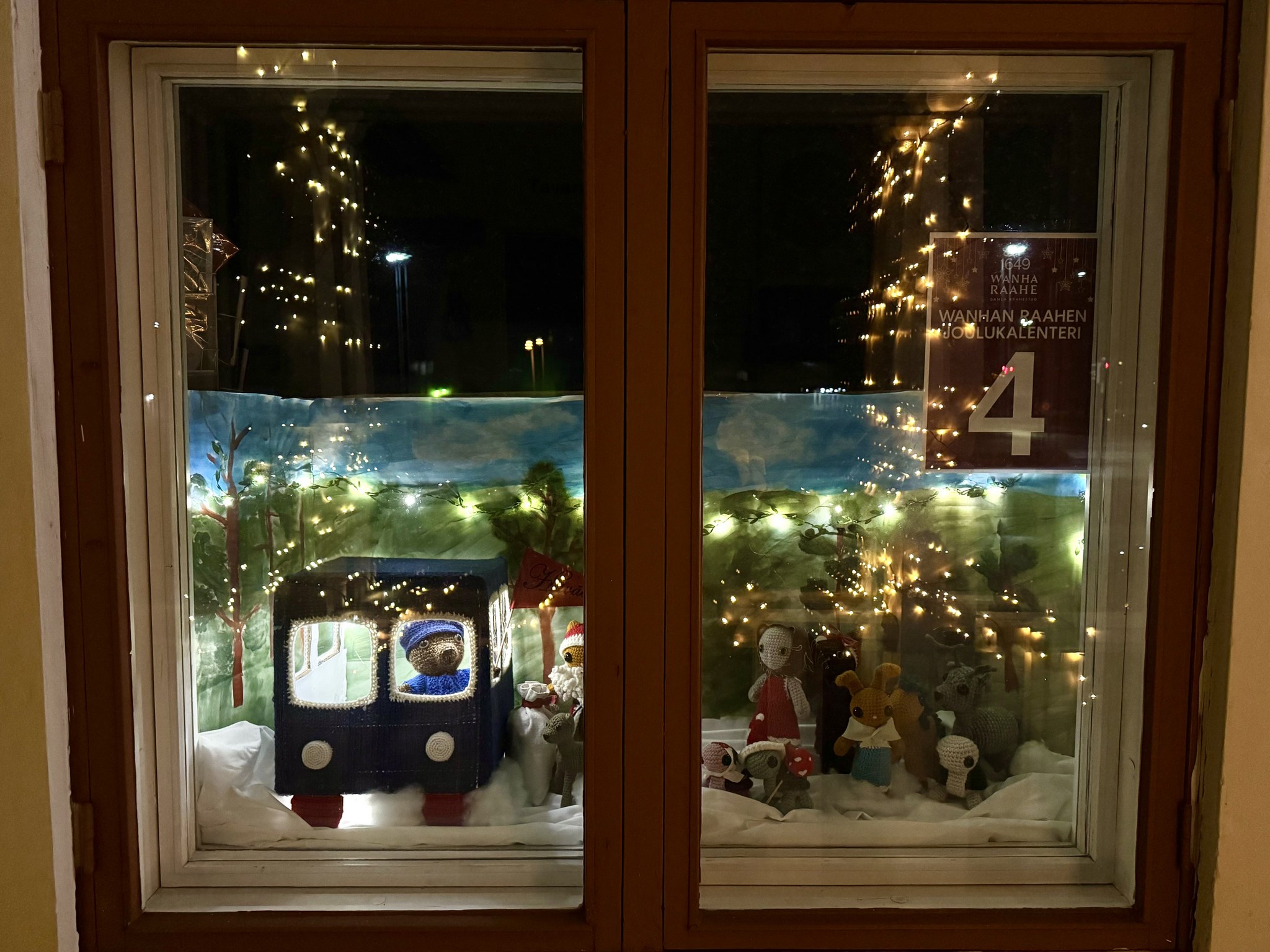Old Town Raahe Advent Calendar window, where animal figures are queueing to a bus.