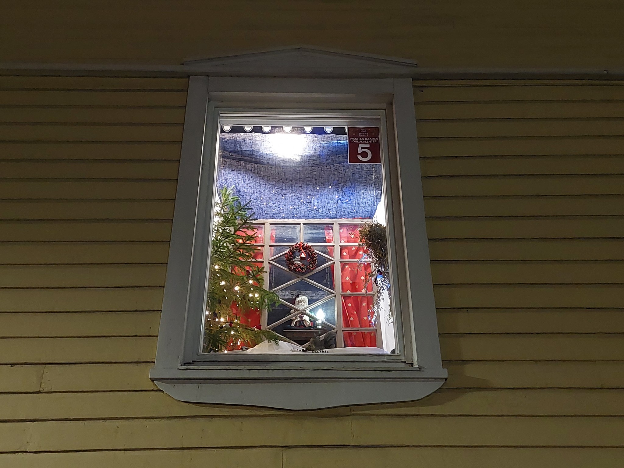 Old Town Raahe Advent Calendar window, where an elf is peeking through a window.