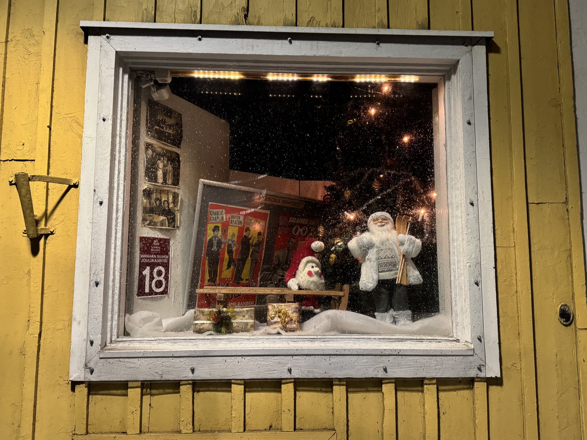 Old Town Raahe Advent Calendar window with Santa, an elf and pictures from cinema.