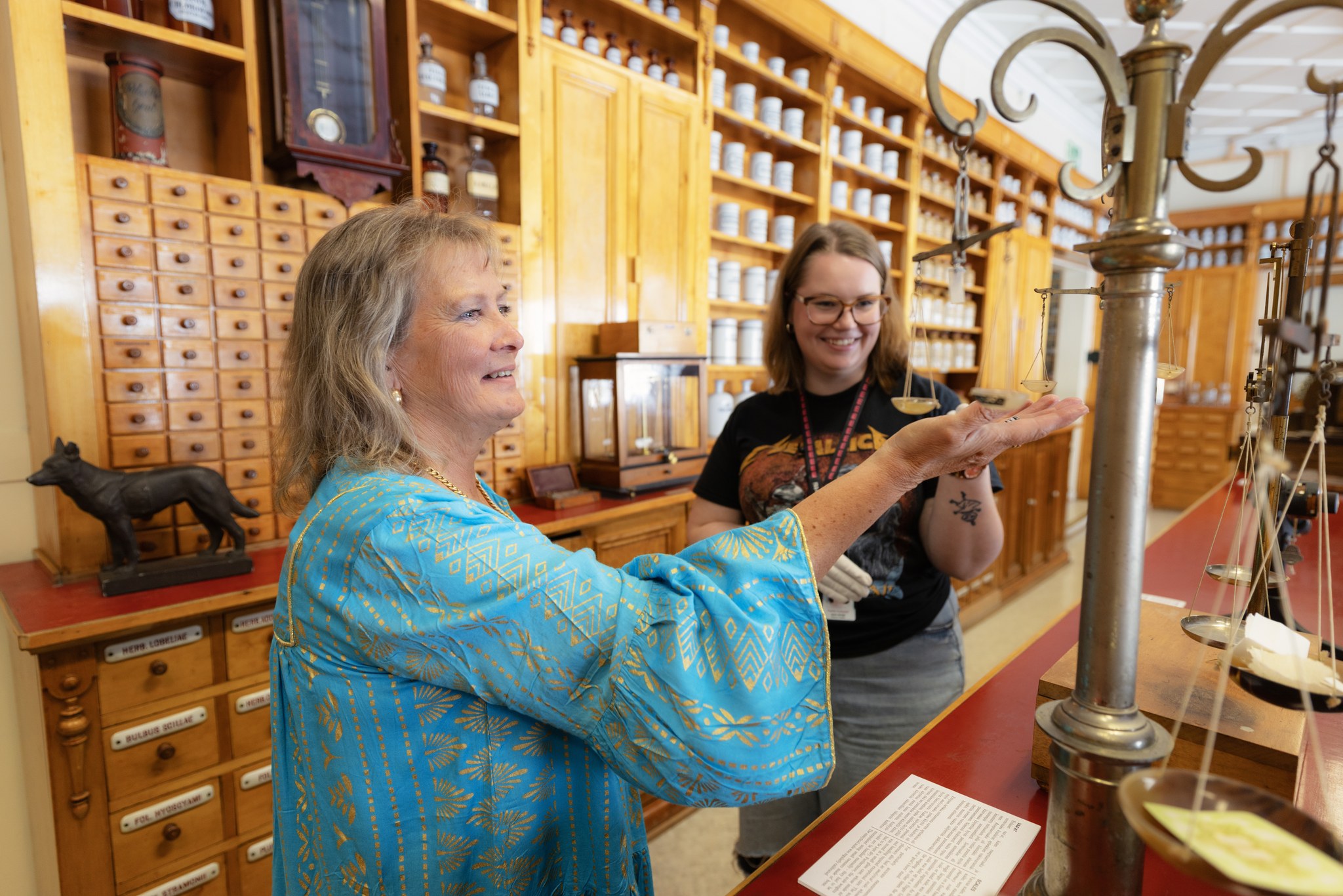 Two people admiring the collection of Old Pharmacy in Old Town Raahe.