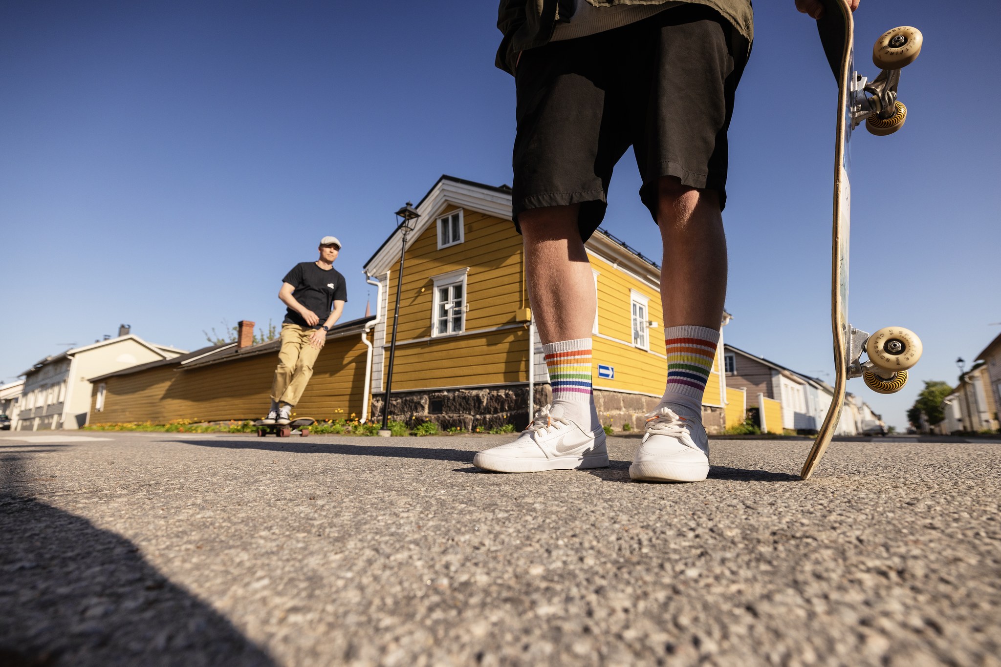 Two people skating in front of the longest wall in Finland in Old Town Raahe.