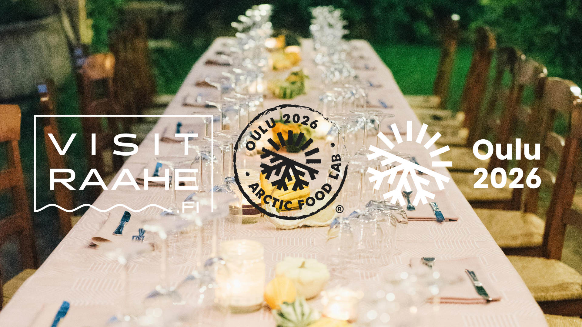 table set with white table cloth, plates, glasses and candles